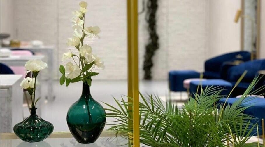 Elegant interior of Naqa Nails, Diriyah, Riyadh Province, SA with green vases and white flowers.