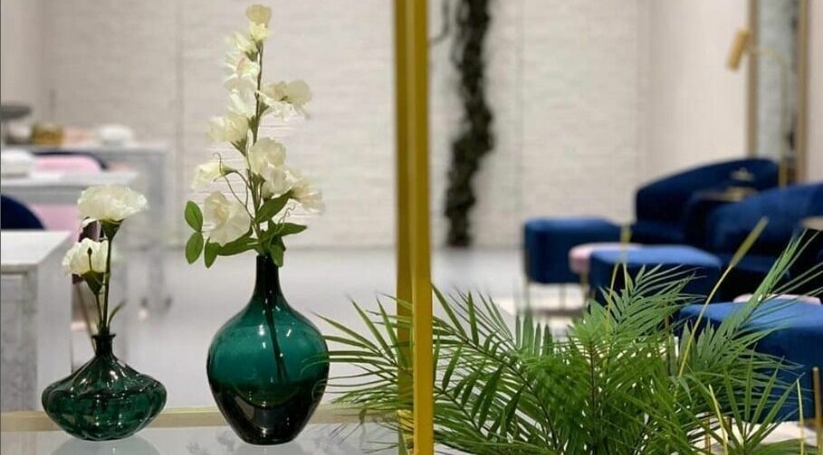 Elegant interior of Naqa Nails, Diriyah, Riyadh Province, SA with green vases and white flowers.