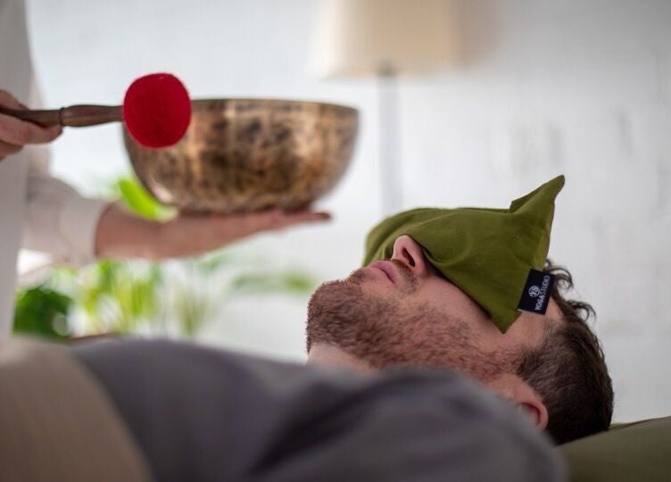 Relaxation therapy at The Tides, Leeds, GB: person receiving a soothing sound bath with calming eye pillow.