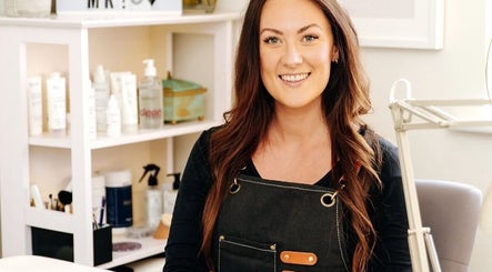 Nail artist smiling at Fleur’s Nails MK in Milton Keynes, England, GB, showcasing a welcoming salon environment.