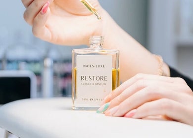 Nail treatment with cuticle oil at Fleur’s Nails MK, Milton Keynes, England, GB.