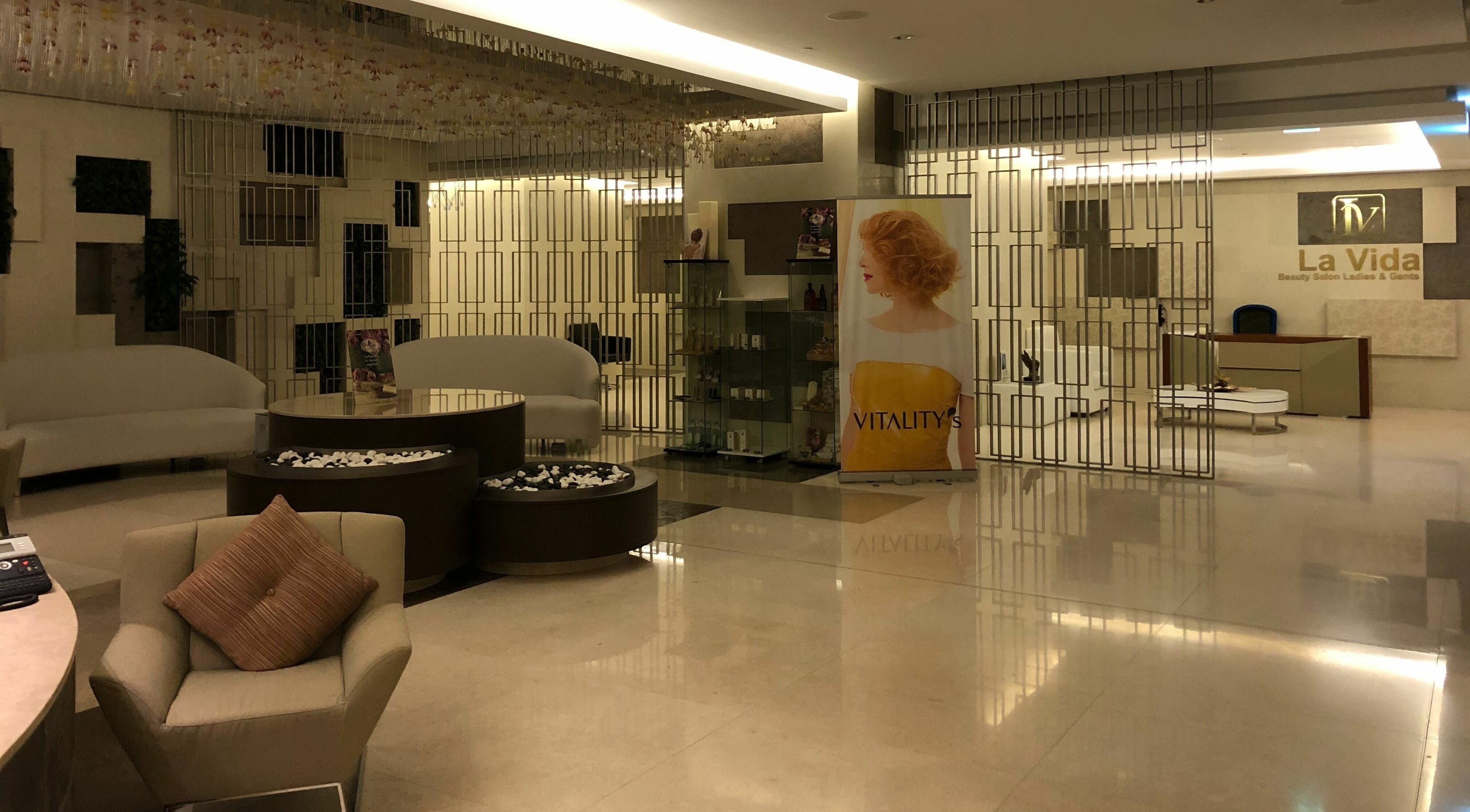 Spacious lounge area of Jean Paul Salon in Dubai, AE with modern decor and stylish seating.