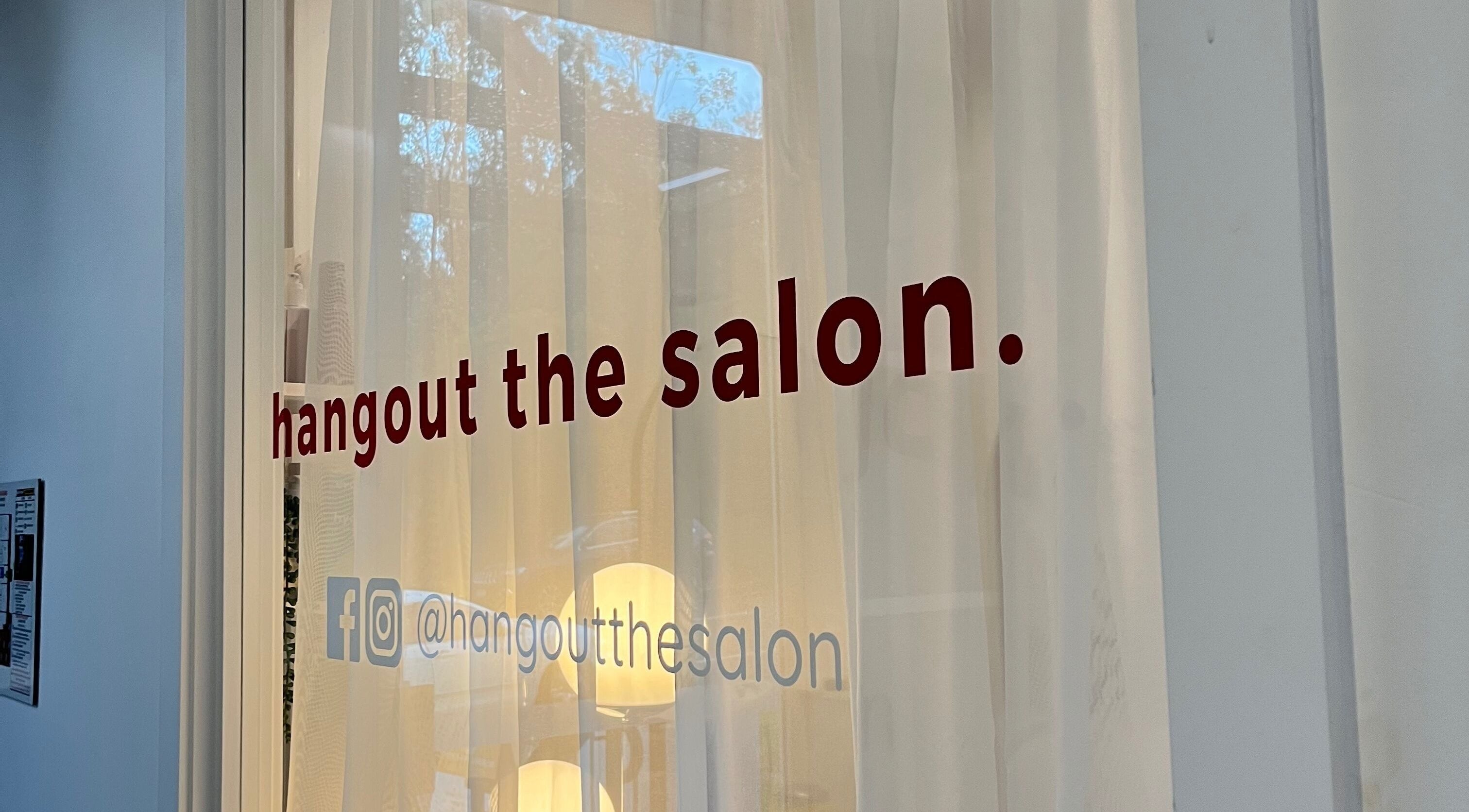 Hangout the Salon window display at Albany Creek, Queensland, AU beautifully showcasing its inviting sign.