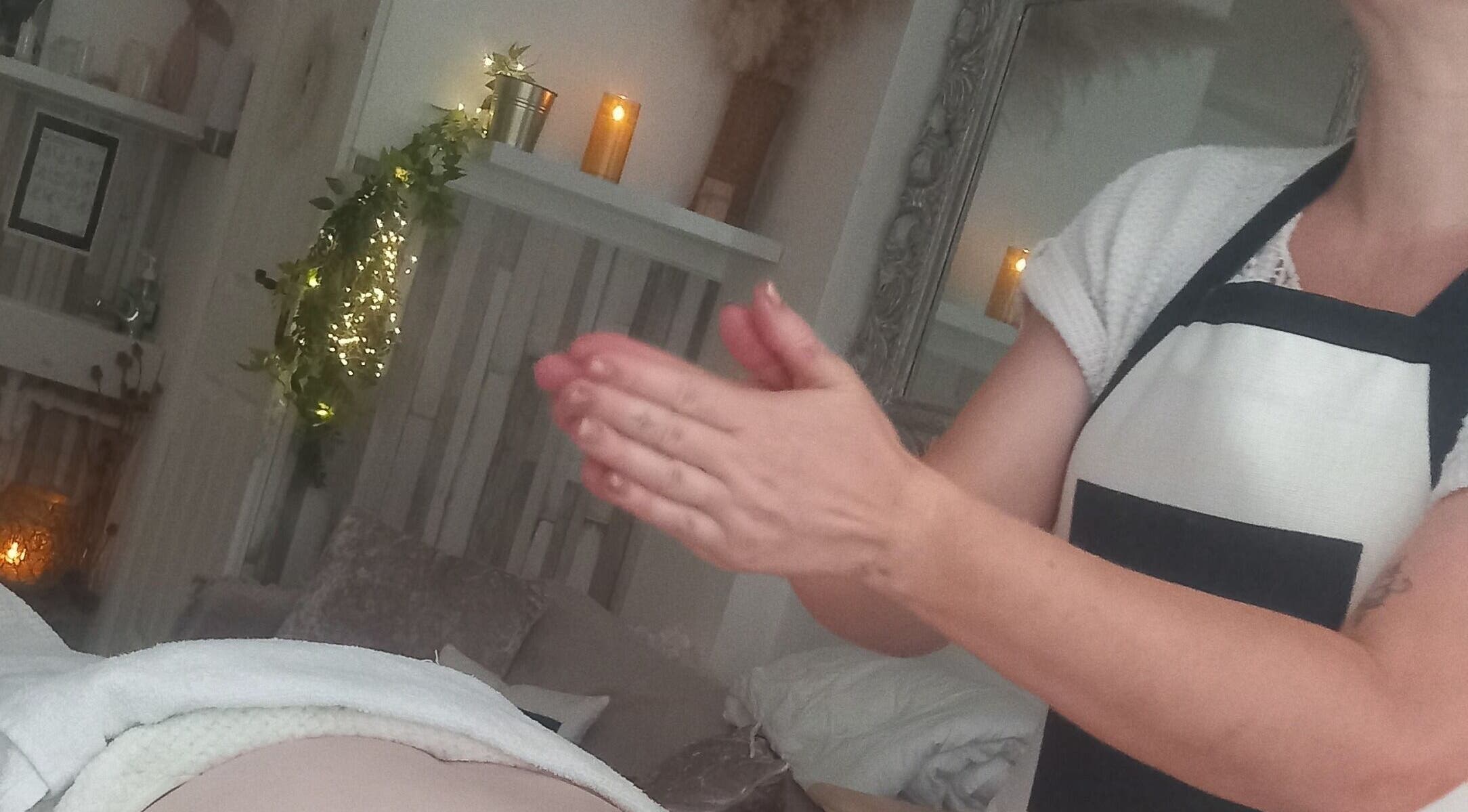 Relaxing massage session at HENYO Studio, BRIDGNORTH, England in a soothing ambiance with candles and greenery.