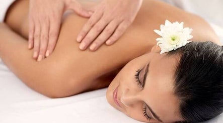 Relaxing massage at Organic Body Therapies, Christchurch, Canterbury, NZ with a white flower accent.