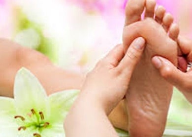 Foot massage at Organic Body Therapies, Christchurch, Canterbury, NZ with floral background.