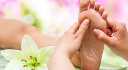 Foot massage at Organic Body Therapies, Christchurch, Canterbury, NZ with floral background.