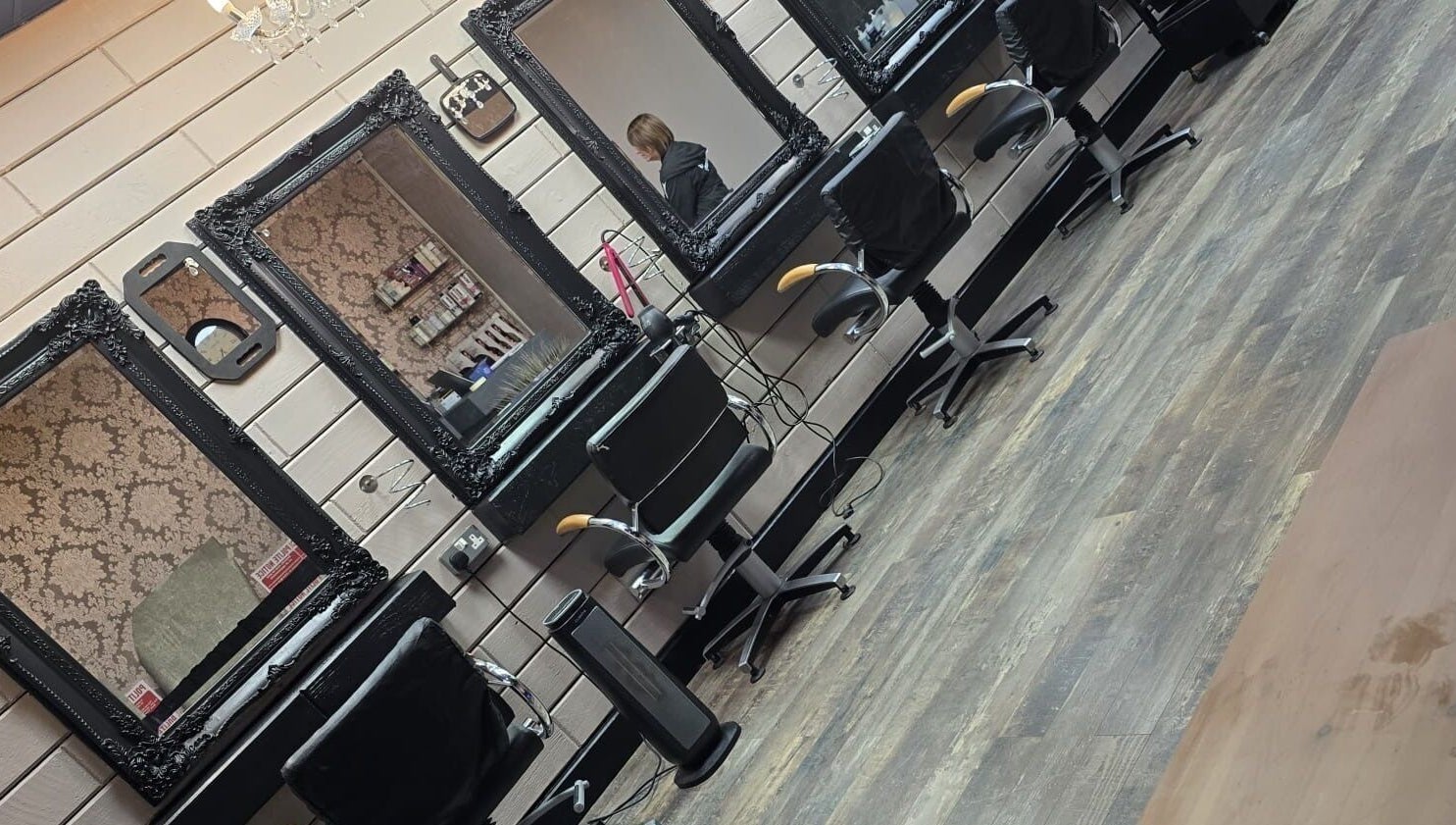 Elegant styling stations at The Hub Hair and Beauty, Sunderland, England, GB with ornate mirrors and chairs.