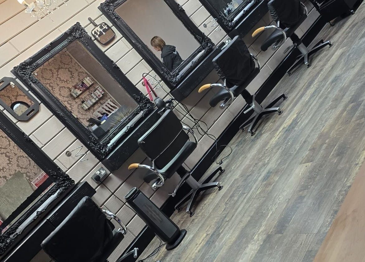 Elegant styling stations at The Hub Hair and Beauty, Sunderland, England, GB with ornate mirrors and chairs.