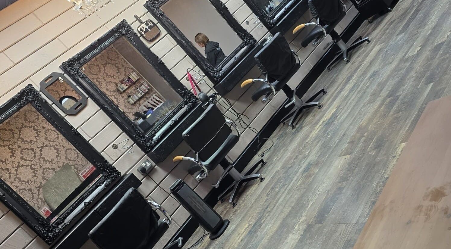 Elegant styling stations at The Hub Hair and Beauty, Sunderland, England, GB with ornate mirrors and chairs.