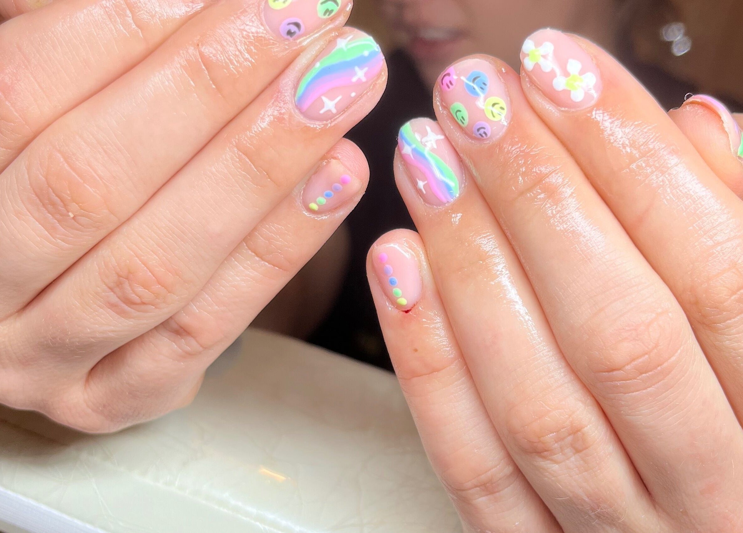 Colorful nail art with rainbows and flowers at Clos Beauty in Peterborough, England, GB.