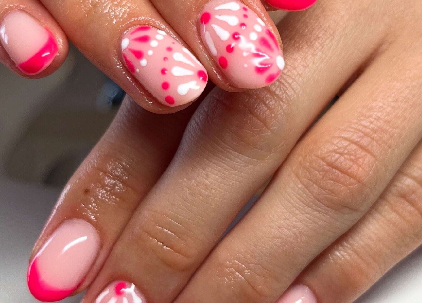 Elegant pink and white floral nail art at Clos Beauty, Peterborough, England, GB, showcasing detailed manicure skills.