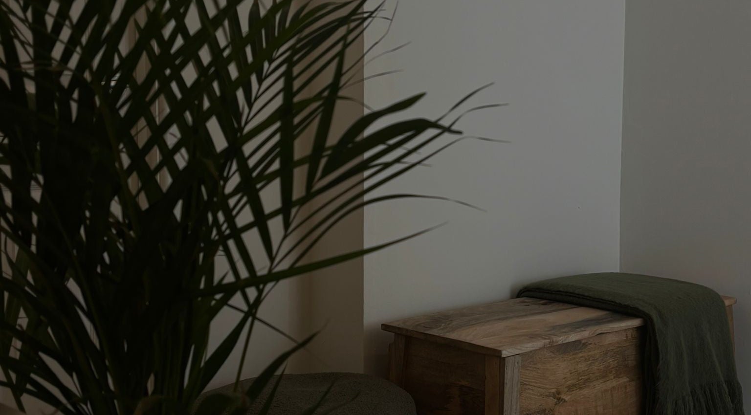 Tranquil corner at Beauty by Leila in Rugby, England with wooden decor and lush greenery.