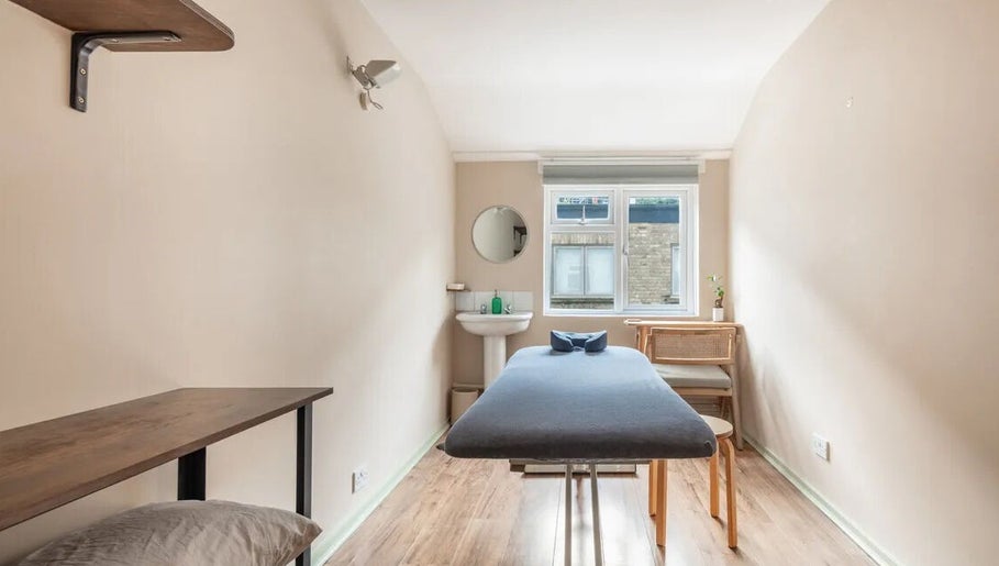 Serene therapy room at Alice Pearl Somatics, London, England, GB with massage table and window light.