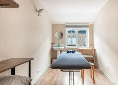 Serene therapy room at Alice Pearl Somatics, London, England, GB with massage table and window light.