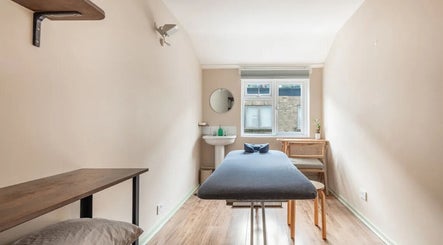 Serene therapy room at Alice Pearl Somatics, London, England, GB with massage table and window light.