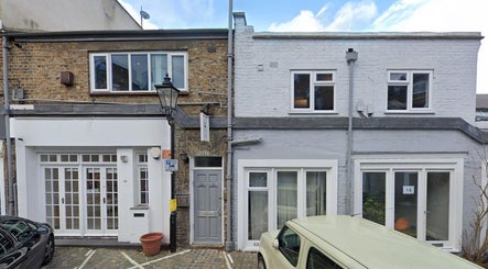 Front of Alice Pearl Somatics in London, England, GB. Brick facade with white-framed doors and windows.