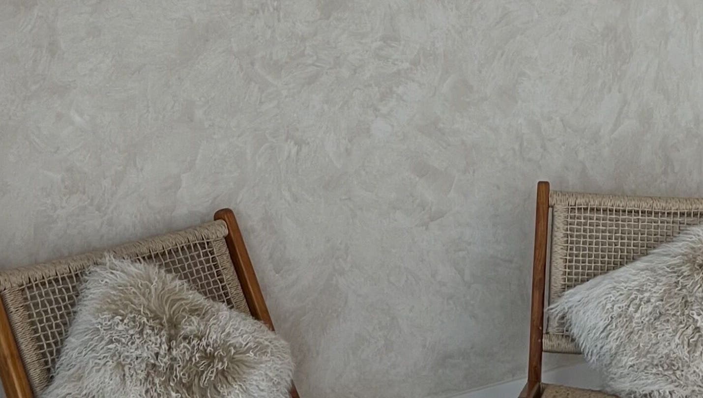 Elegant seating area at Hasana in Griffith, Australian Capital Territory, AU with stylish woven chairs and plush cushions.