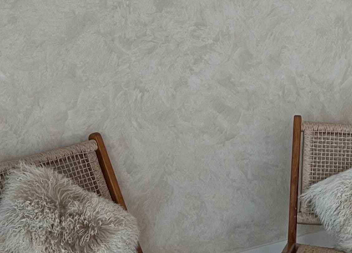 Elegant seating area at Hasana in Griffith, Australian Capital Territory, AU with stylish woven chairs and plush cushions.