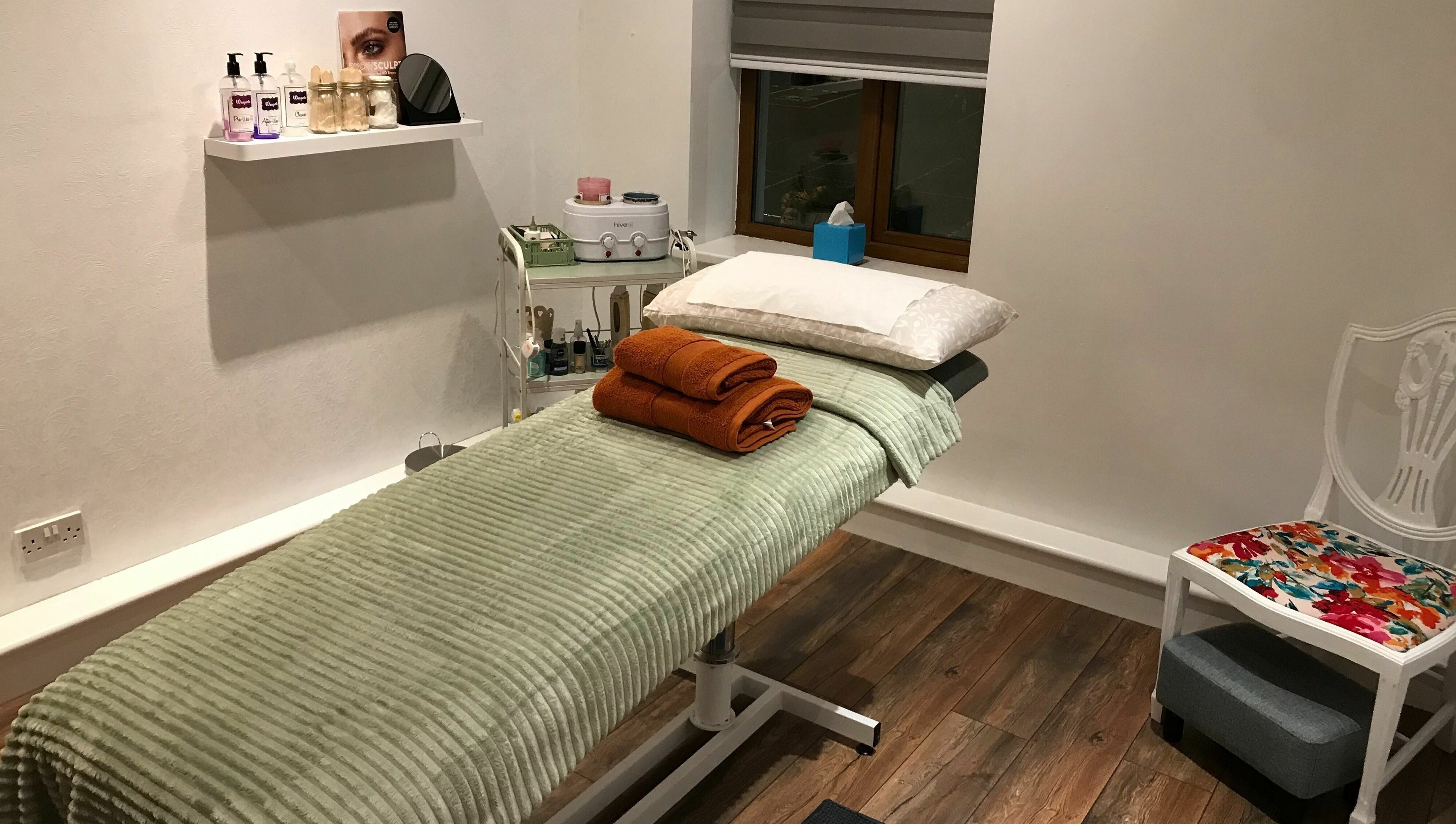 Cozy treatment room at Wild Beauty, Clifden, County Galway, IE, featuring a plush massage table and soothing decor.
