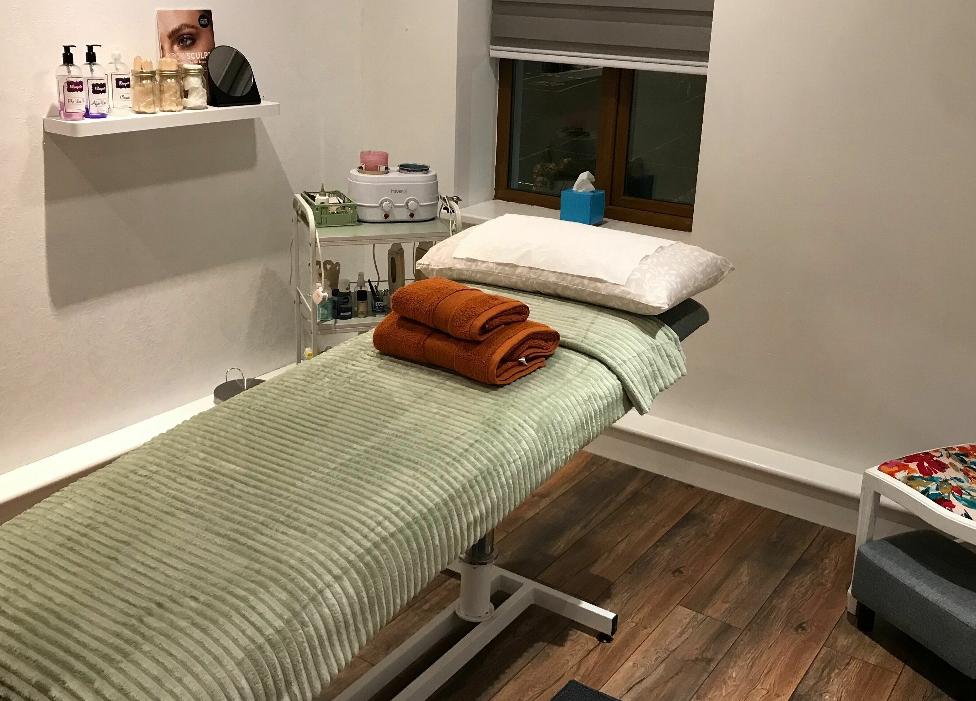 Cozy treatment room at Wild Beauty, Clifden, County Galway, IE, featuring a plush massage table and soothing decor.