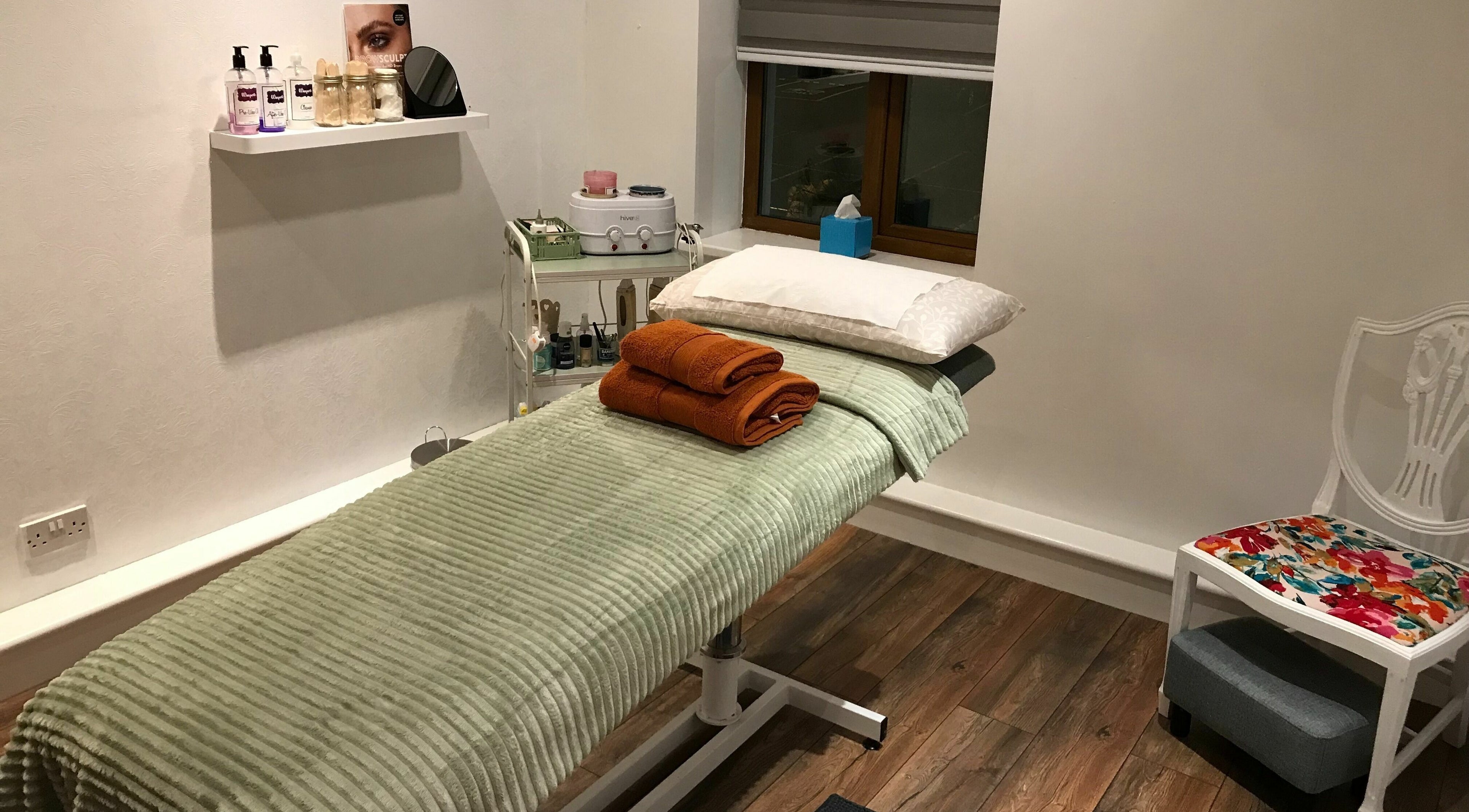 Cozy treatment room at Wild Beauty, Clifden, County Galway, IE, featuring a plush massage table and soothing decor.