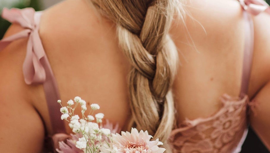 Elegant braided hairstyle with floral accents at CURA, Trail, British Columbia, CA.
