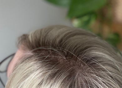 Close-up of a blonde head of hair at CURA, Trail, British Columbia, CA showcasing their hair treatment services.