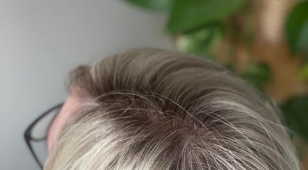 Close-up of a blonde head of hair at CURA, Trail, British Columbia, CA showcasing their hair treatment services.