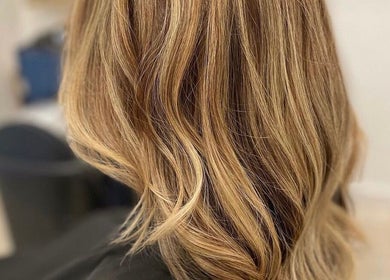Lustrous golden hair styled at CURA, Trail, British Columbia, CA. Perfect for elegant beauty transformations.