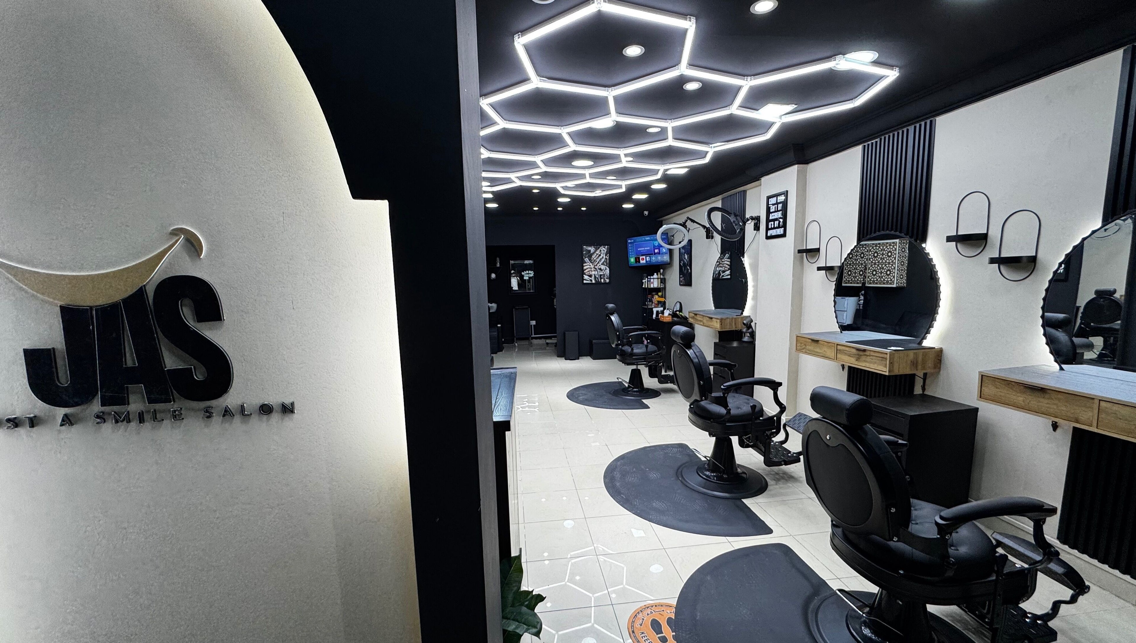 Spacious interior of Just A Smile Salon, Doha, Doha Municipality, QA with stylish modern lighting and salon chairs.