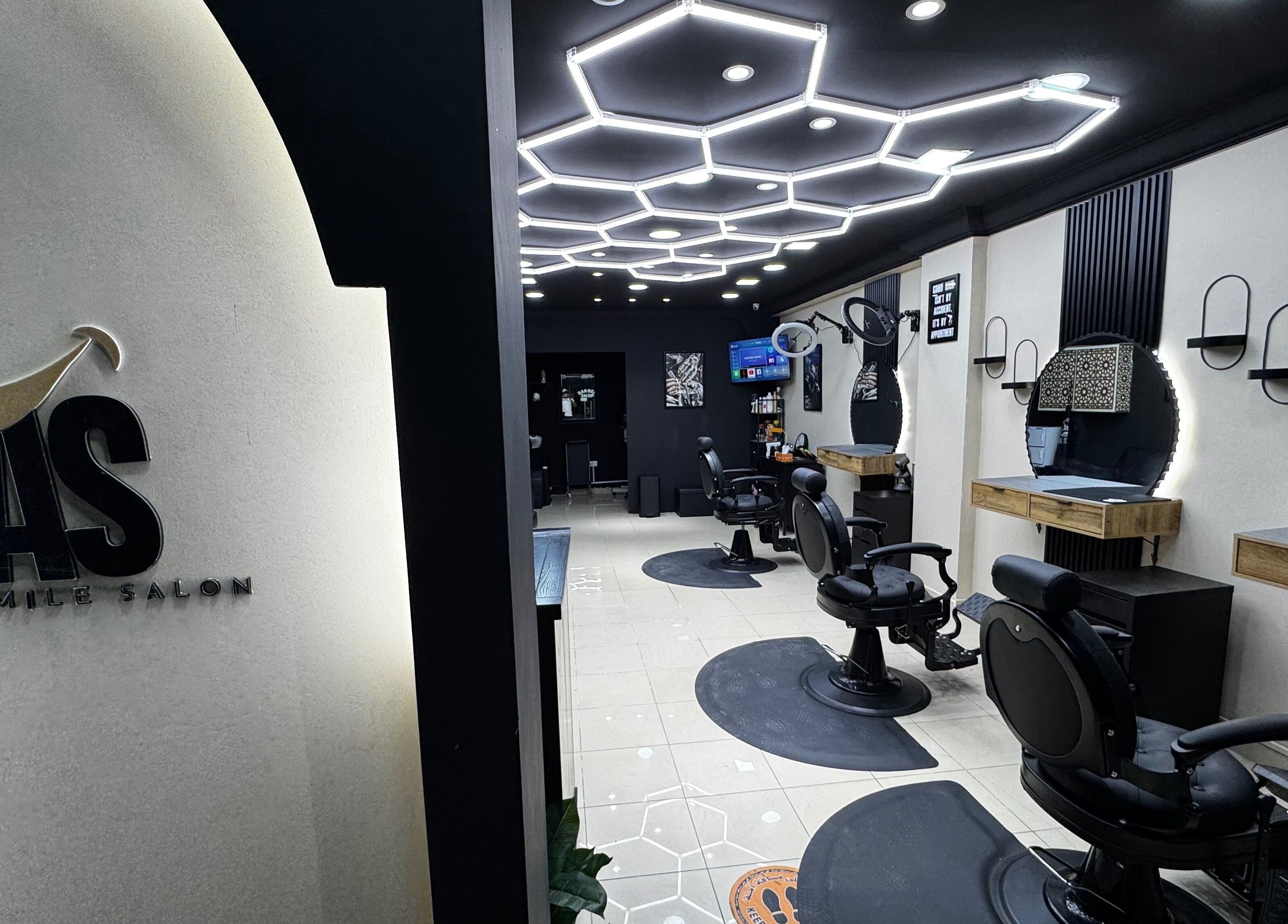 Spacious interior of Just A Smile Salon, Doha, Doha Municipality, QA with stylish modern lighting and salon chairs.