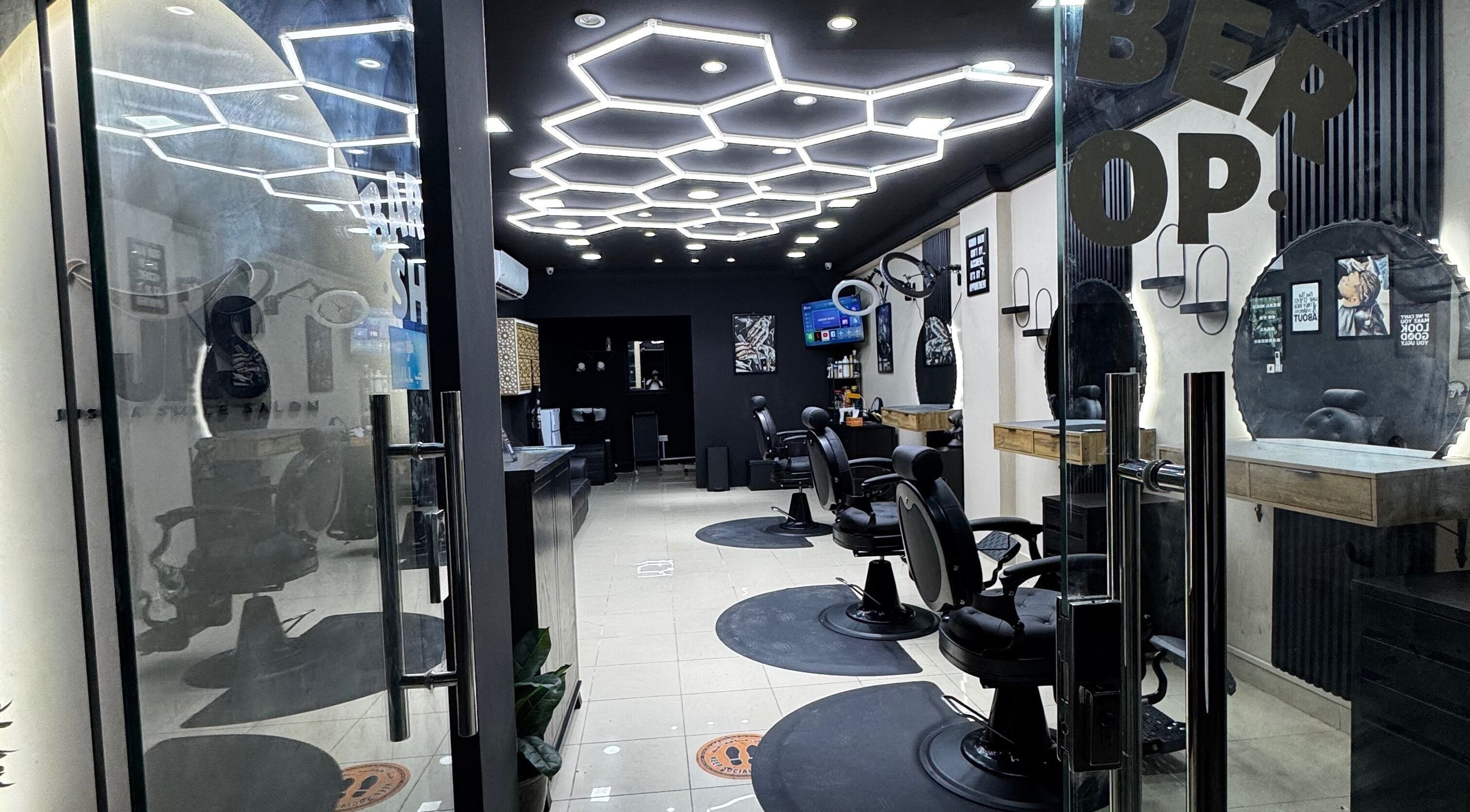 Modern barber chairs at Just A Smile Salon in Doha, Doha Municipality, QA, featuring stylish decor and lighting.