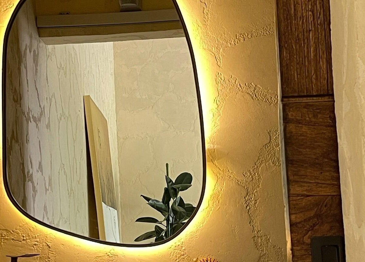 Illuminated mirror at Face Therapy Spa, Umalas in Bali, ID offers a warm, inviting ambiance.