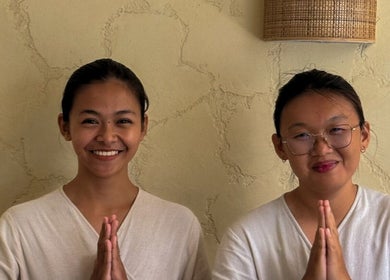 Two smiling staff greet at Face Therapy Spa, Umalas in Bali, ID, enhancing wellness experience.
