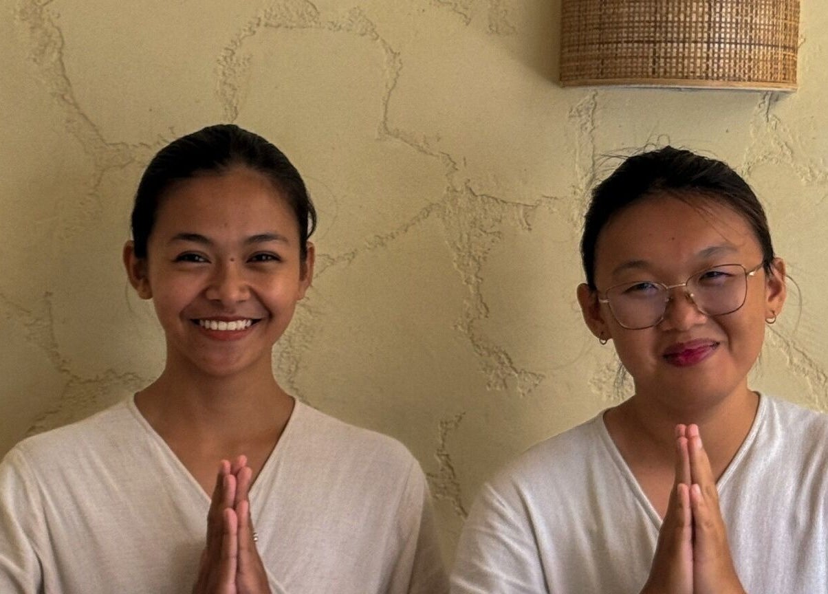 Two smiling staff greet at Face Therapy Spa, Umalas in Bali, ID, enhancing wellness experience.