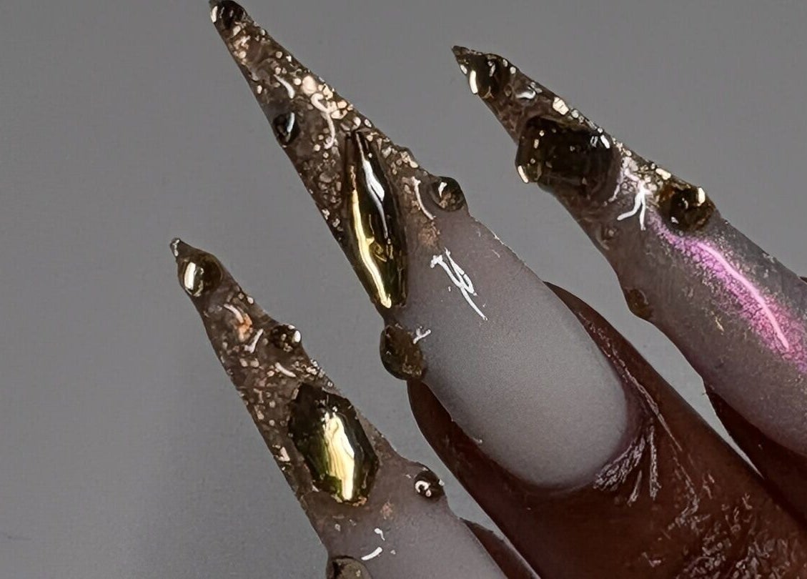 Intricate nail art with metallic accents at Thee Adore Beauty Bar, London, England, GB.