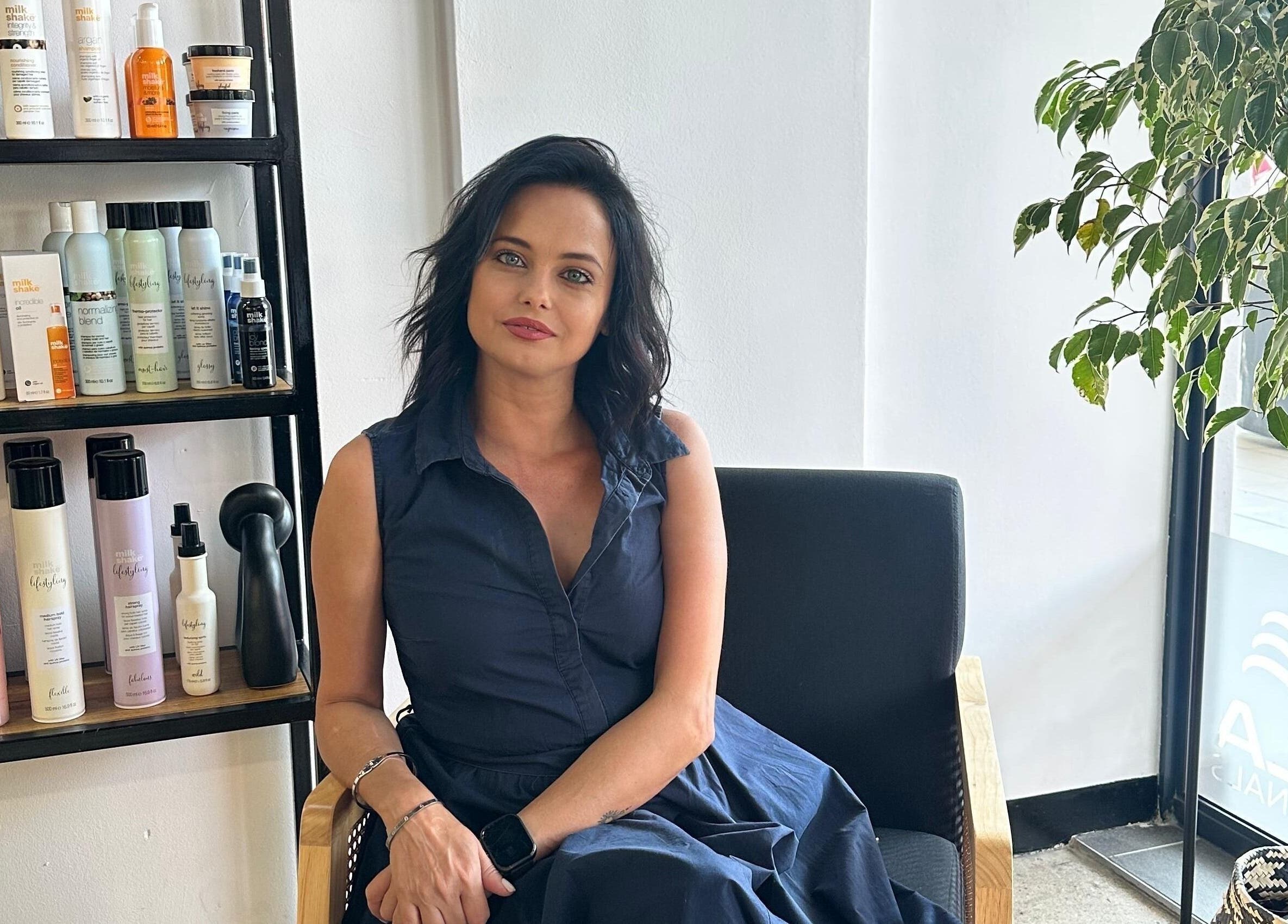 Melinda Marx at The Haircompany, sitting, amid beauty products in Umhlanga, Kwazulu-natal, ZA.