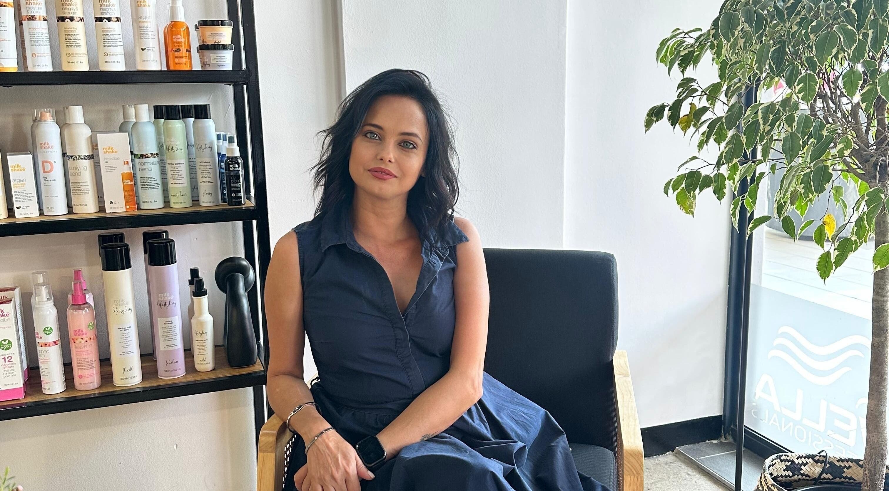 Melinda Marx at The Haircompany, sitting, amid beauty products in Umhlanga, Kwazulu-natal, ZA.