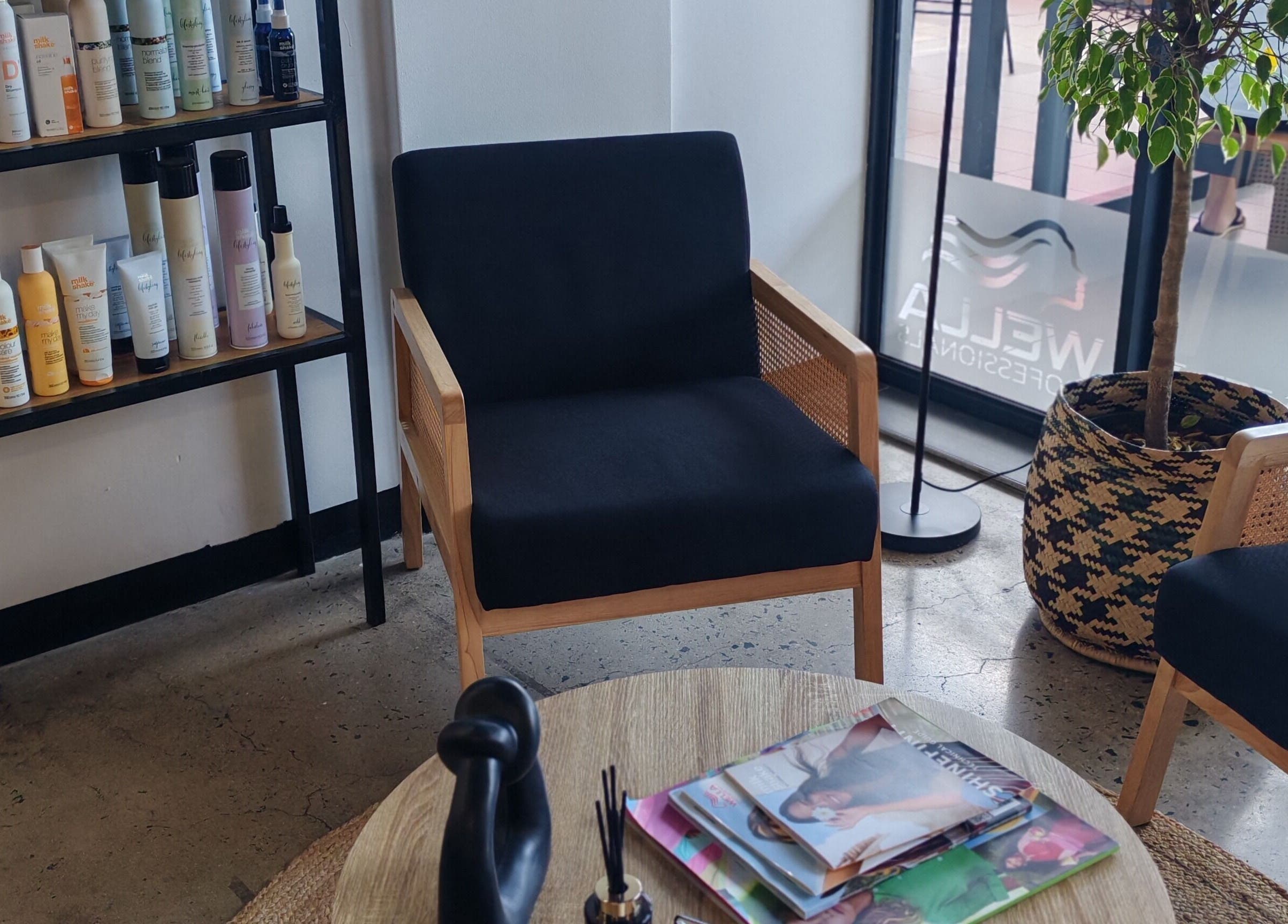 Relaxing waiting area at Melinda Marx at The Haircompany, Umhlanga, Kwazulu-natal, ZA with hair products displayed.