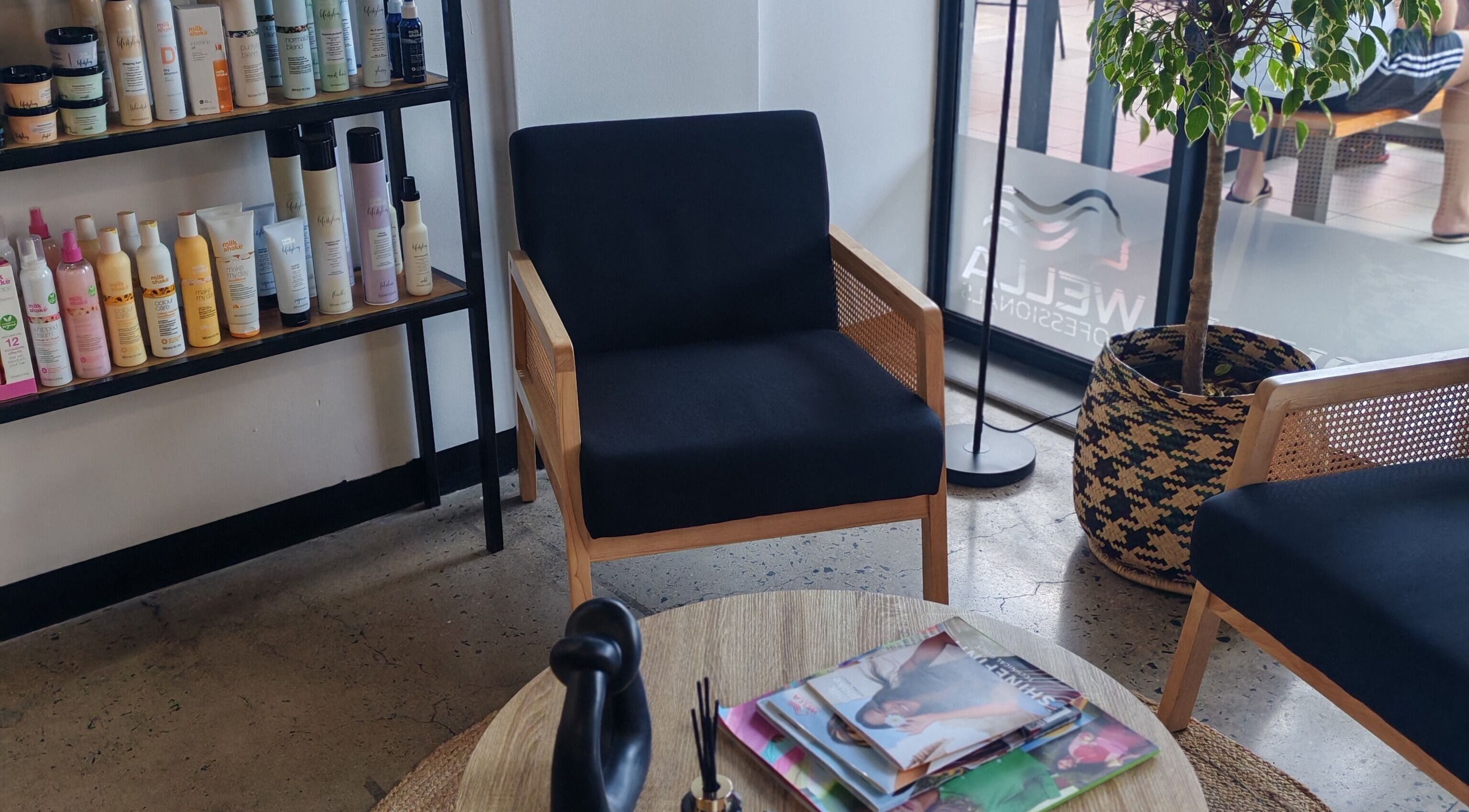 Relaxing waiting area at Melinda Marx at The Haircompany, Umhlanga, Kwazulu-natal, ZA with hair products displayed.