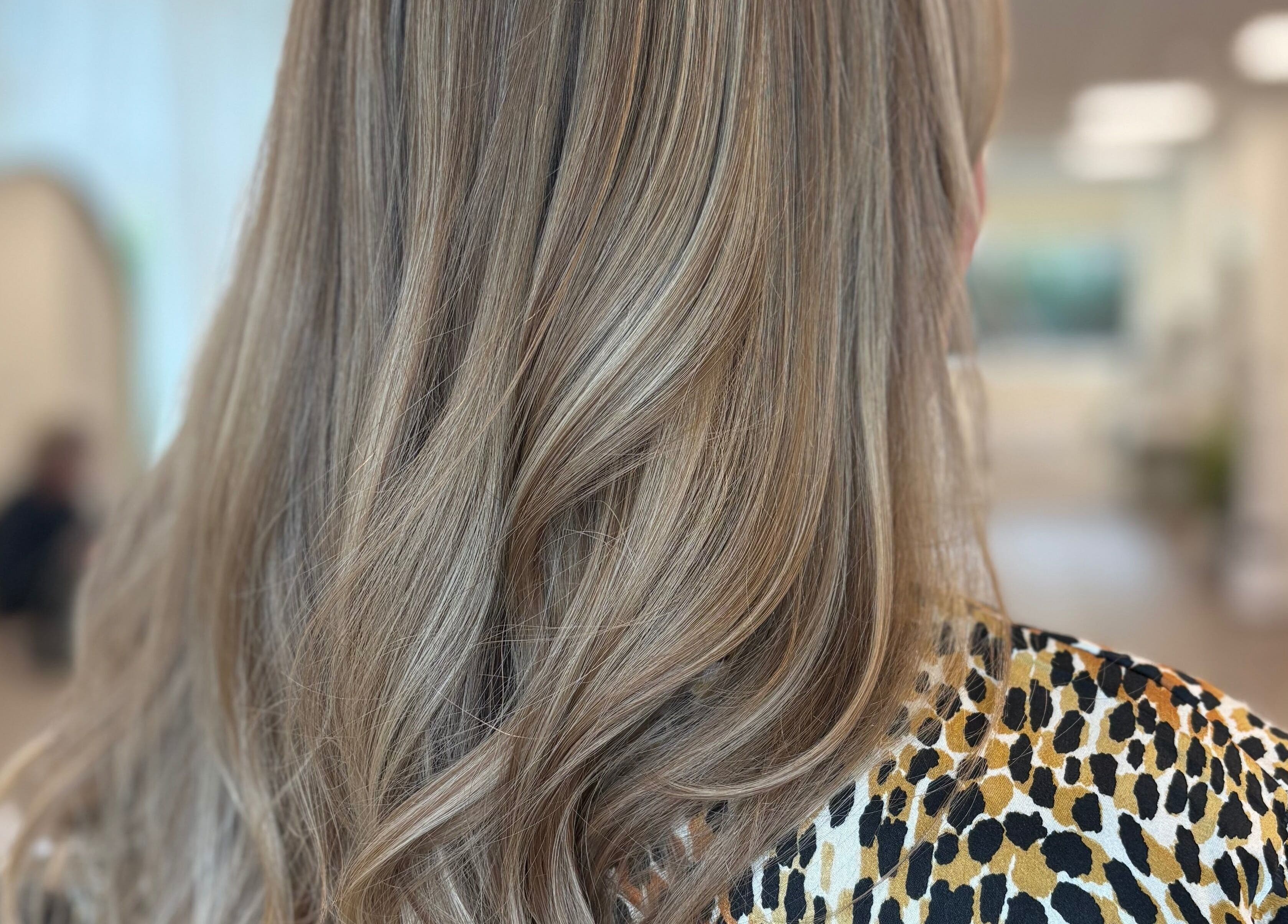 Elegant blonde highlights on flowing hair at Alice Tobin Hair Design in Cardiff, Wales, GB.