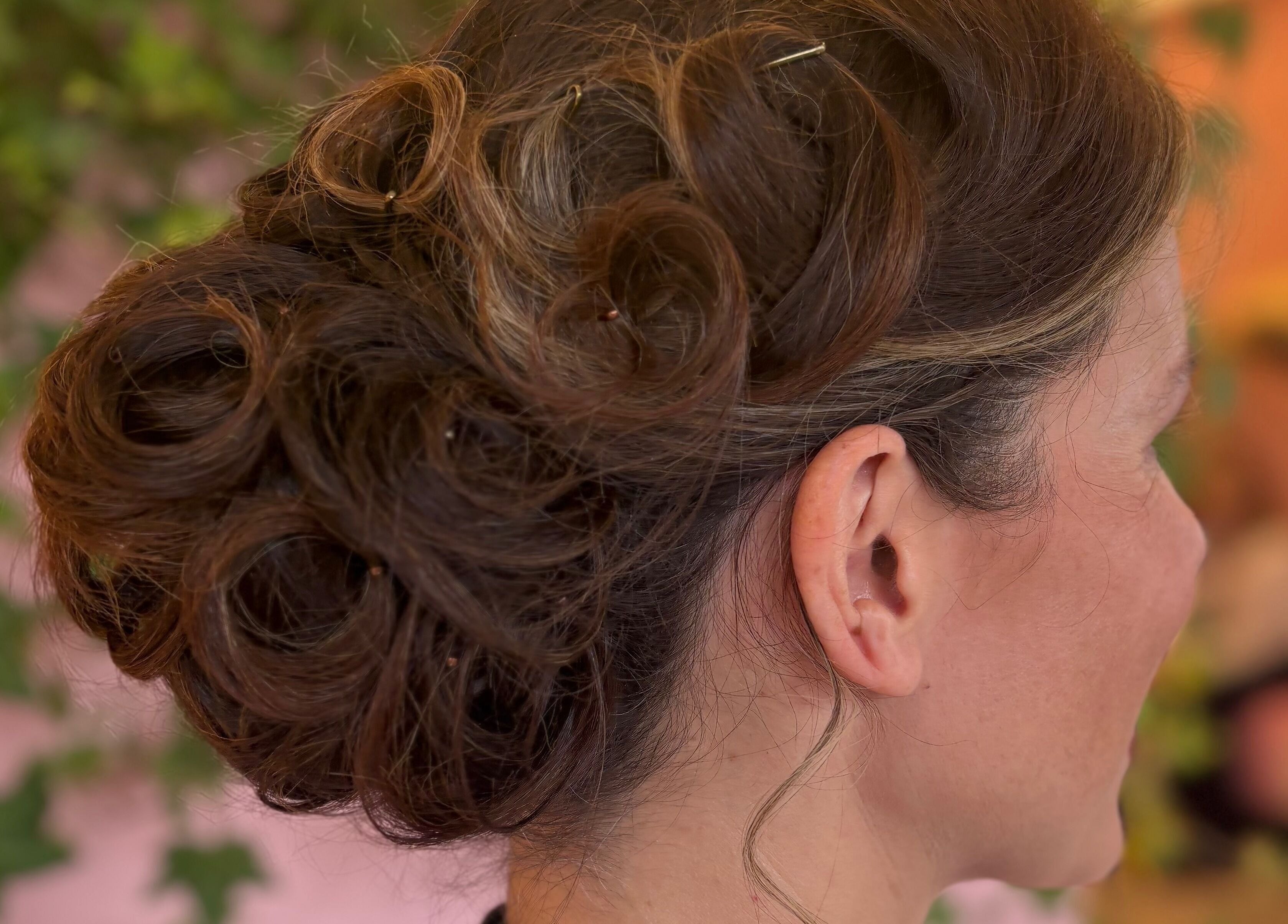 Elegant updo hairstyle at Alice Tobin Hair Design in Cardiff, Wales, GB, showcasing intricate curls.