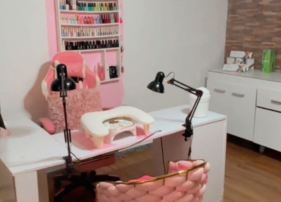 Estación de uñas en Perla spa nails uy, Montevideo, Departamento De Montevideo, UY, con sillas rosadas y estantes de esmaltes.
