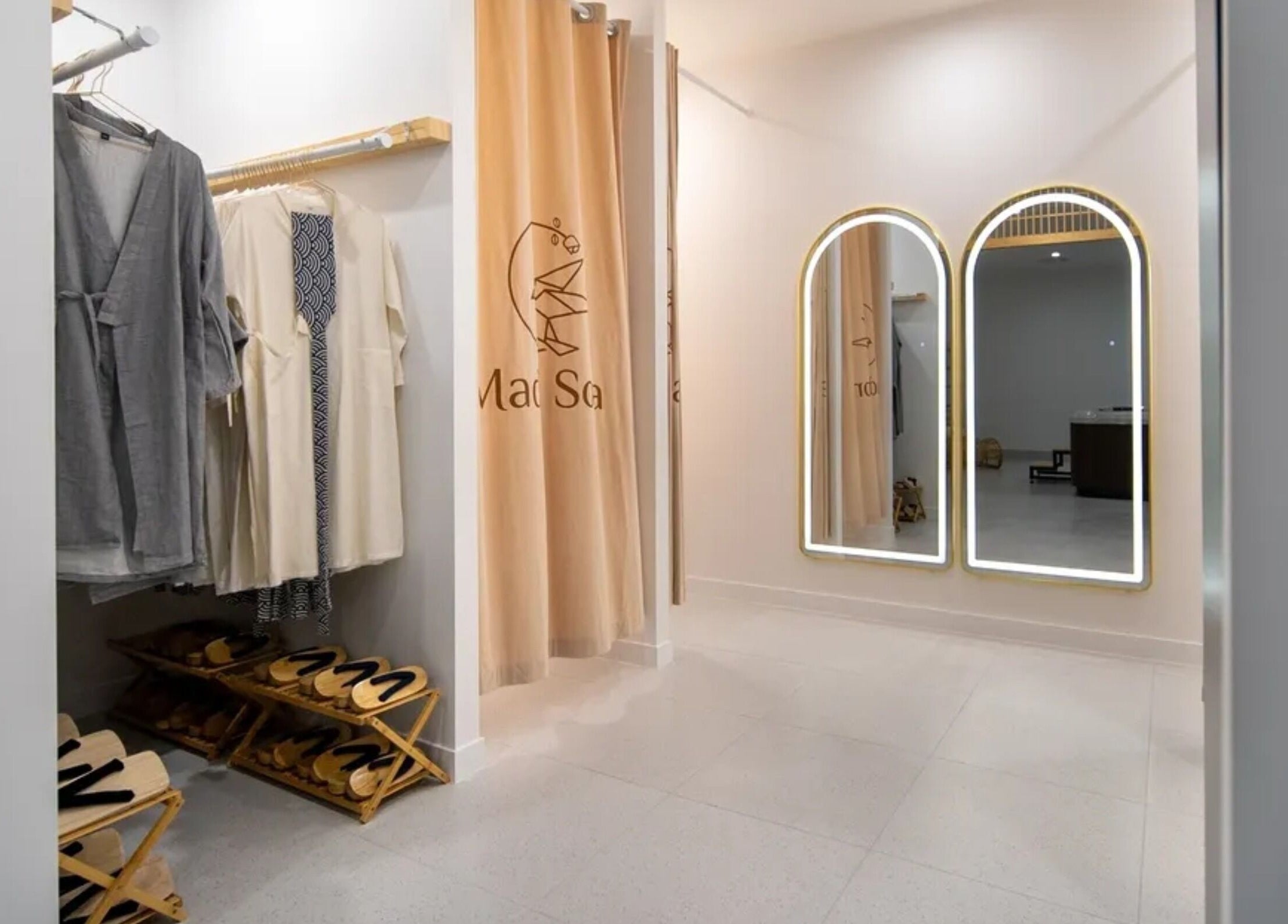 Elegant changing area at Mada Sora Spa, Rural View, Queensland, AU, featuring robes and slippers.