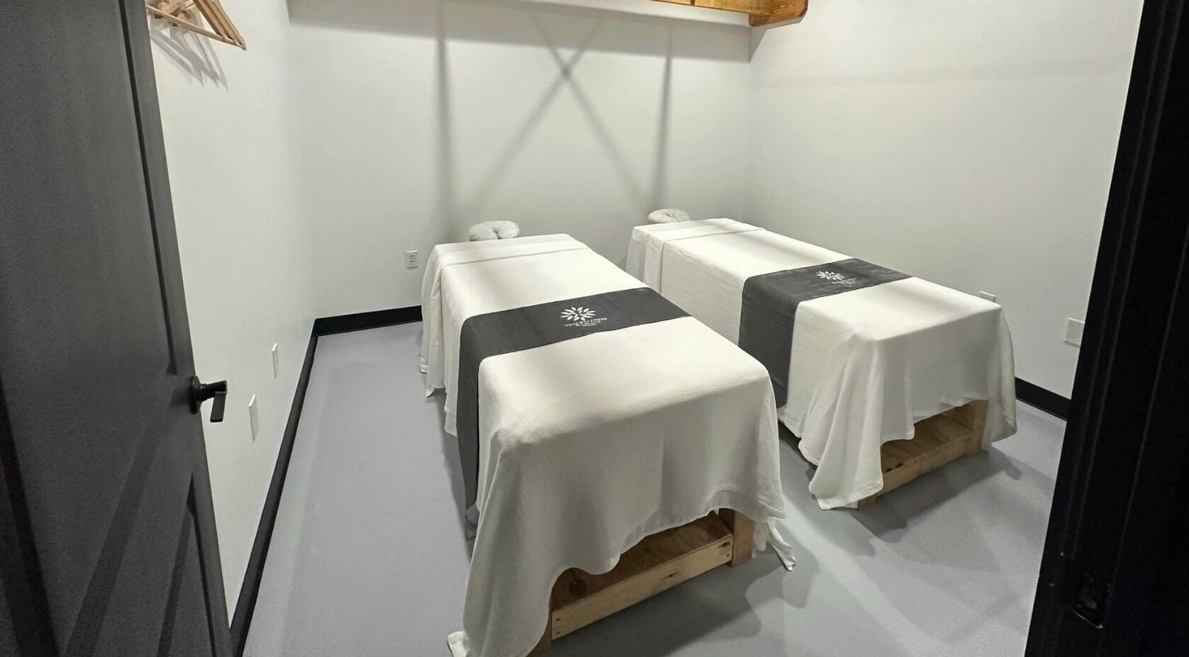 Calming massage room at Thai Wellness Massage in Houston, Texas, US, featuring two neatly prepared massage tables.