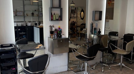 Chic interior of Studio 22 Hairdressing in Stony Stratford, England, GB showcasing sleek styling stations.