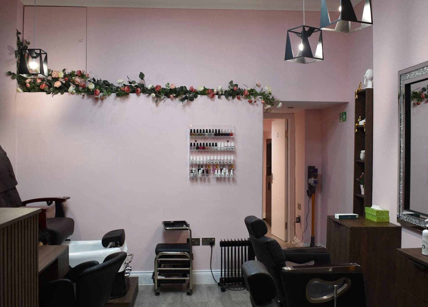Elegant interior of Patel Sisters Aesthetic Beauty Clinic in London, England, GB with soft pink decor and treatment chairs.