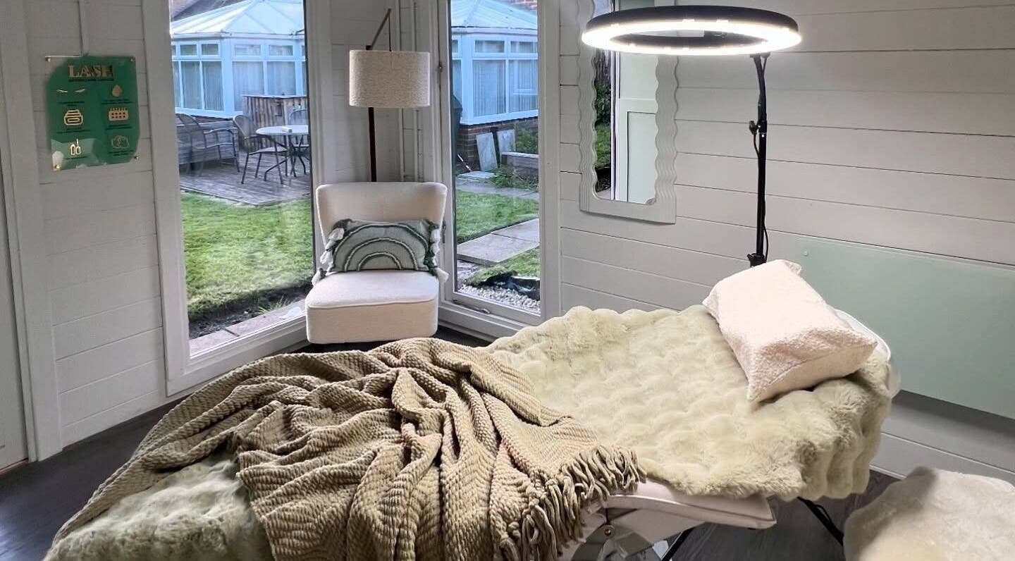 Cozy beauty treatment room at Marci Rae Beauty, Derby, England, GB with plush bed and garden views.