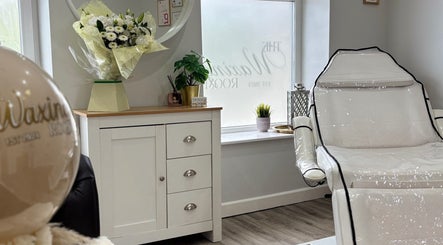 Relaxing treatment area at The Waxing Room, Pencoed, Wales, GB, with stylish white chair and decor.